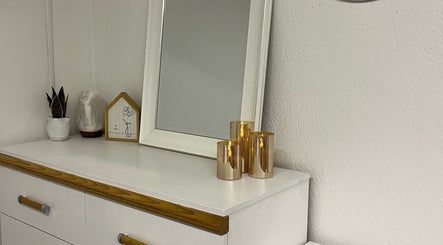Elegant decor at Bridget Wilson Esthetics Studio, Sault Ste. Marie, Ontario, CA with candles and a mirror.