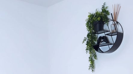 Modern wall shelf with plants at The Laser Bar Essex, Loughton, England, GB, adding a stylish touch.