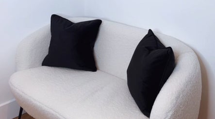 A stylish white sofa with black cushions at The Laser Bar Essex in Loughton, England, GB.