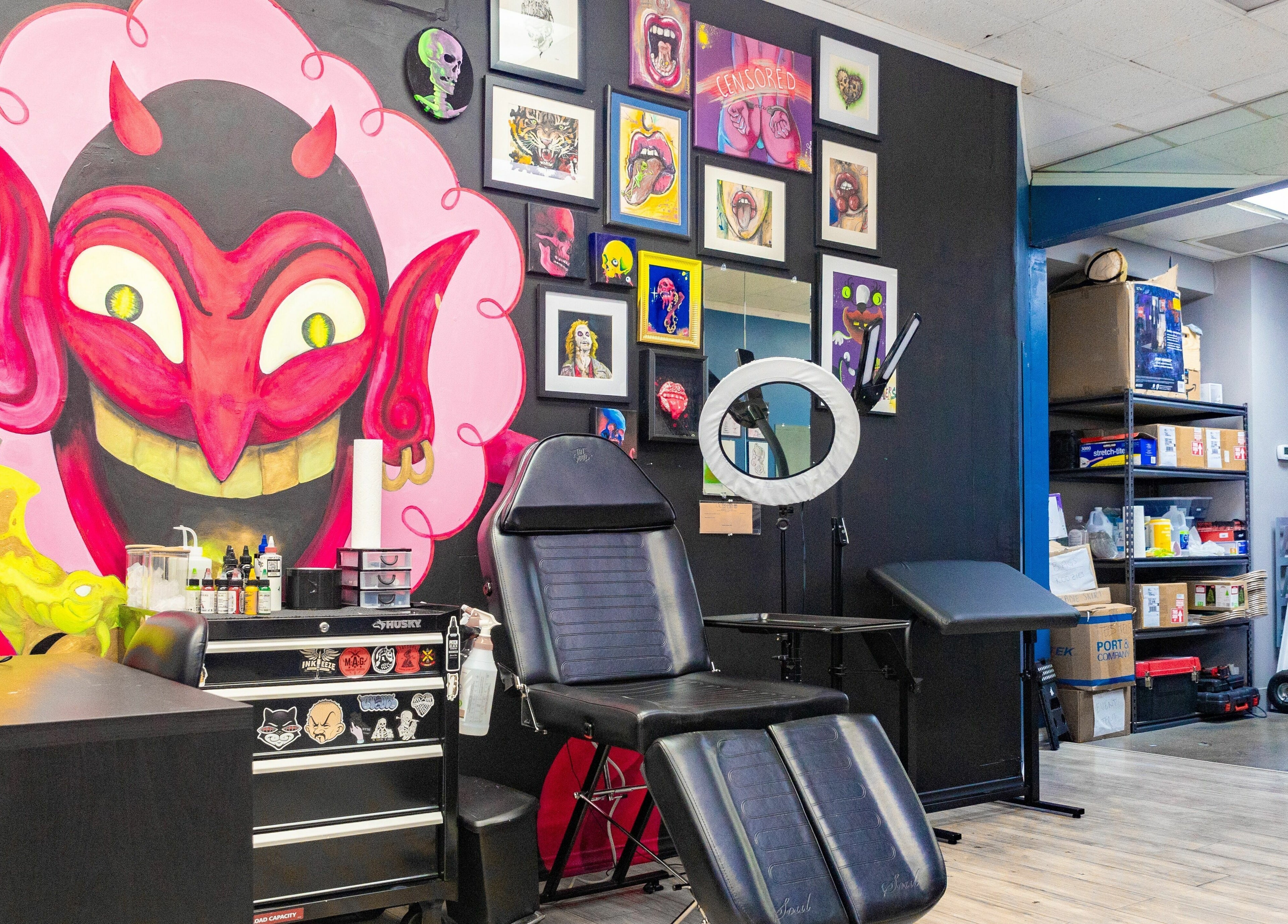 Vibrant tattoo studio wall art and chair at Mr. Inkwells, Los Alamitos, California, US.