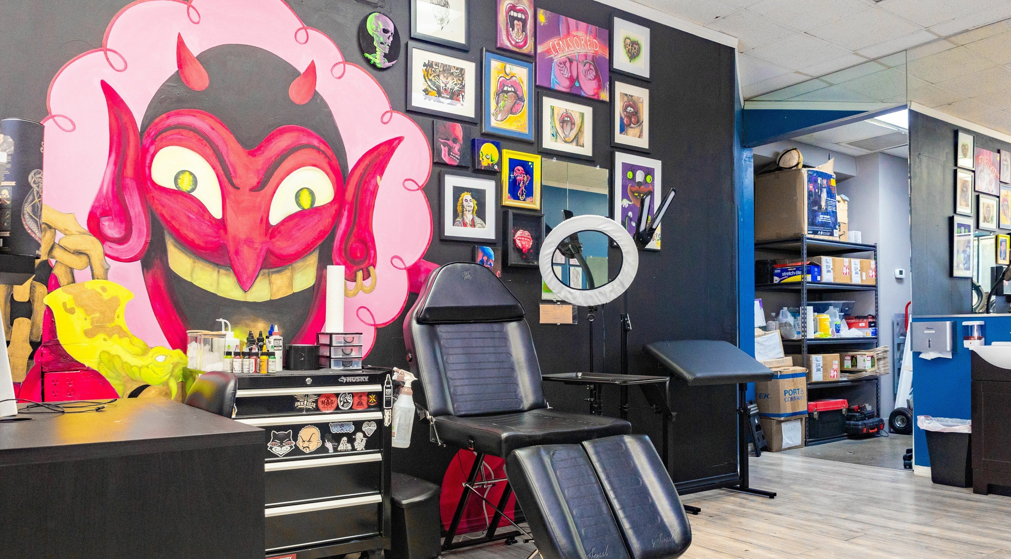 Vibrant tattoo studio wall art and chair at Mr. Inkwells, Los Alamitos, California, US.