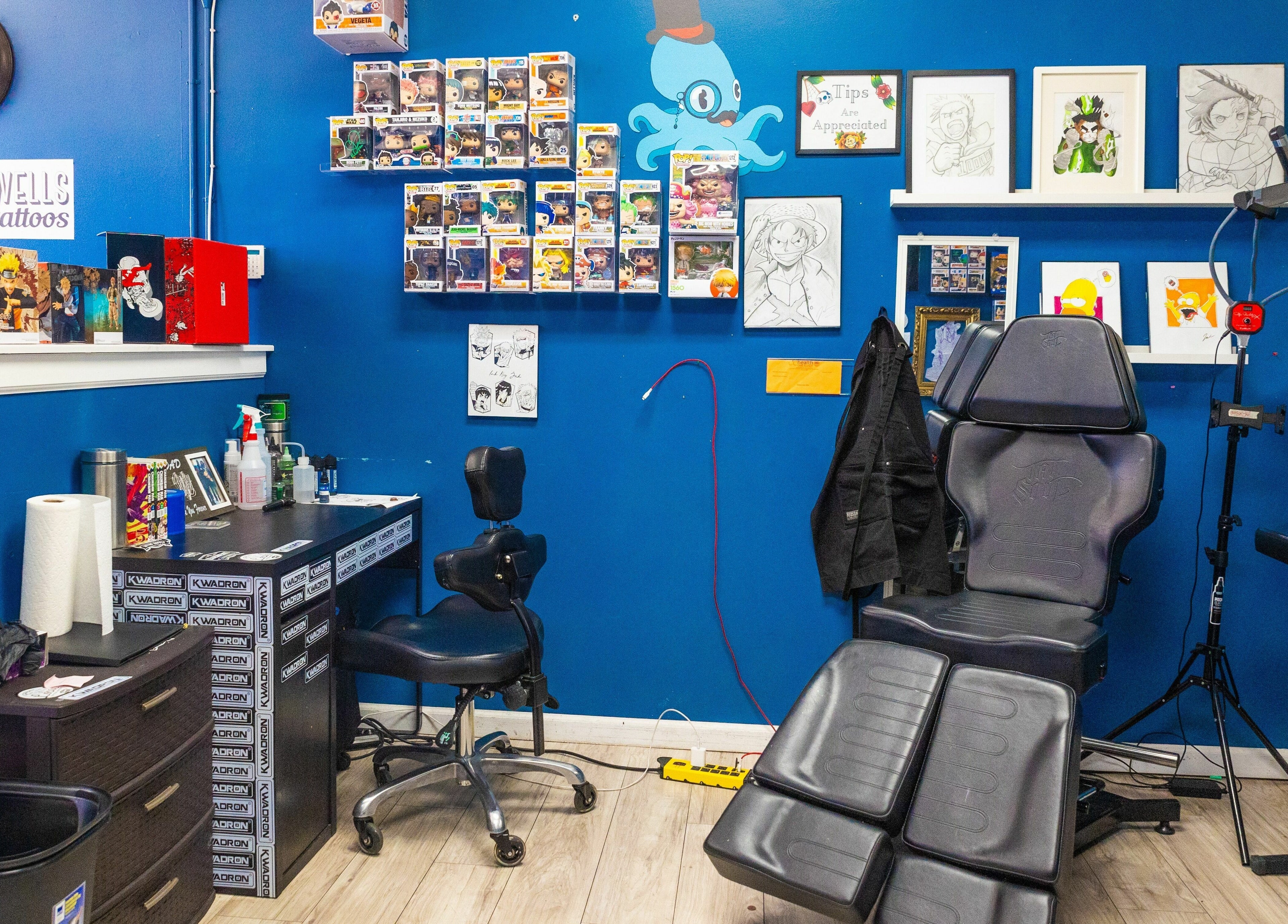 Inside Mr. Inkwells's vibrant tattoo studio in Los Alamitos, California, US, showcasing unique decor and equipment.