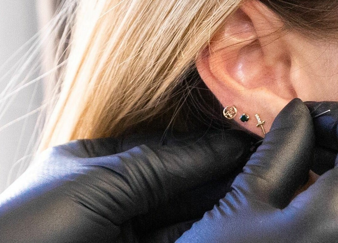 Close-up of ear piercing at Mr. Inkwells, Los Alamitos, California, US, showcasing expert craftsmanship.