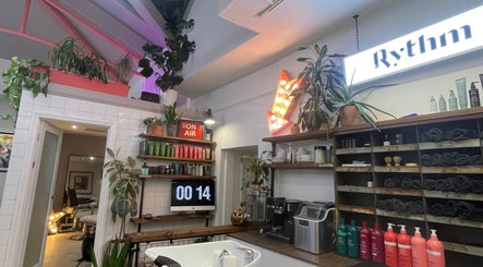 Cozy interior of Rythm Barbering in Bristol, England, GB, featuring vibrant plants and grooming products.