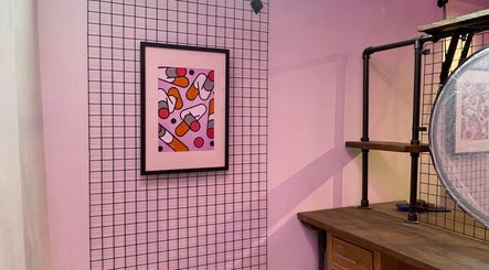 Vibrant wall art in Rythm Barbering, Bristol, England, GB, adds color to the industrial decor.