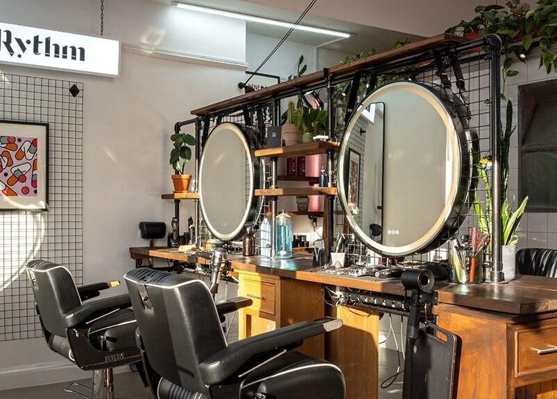 Elegant salon setup at Rythm Studio, featuring chic mirrors and plush chairs in Bristol, England, GB.