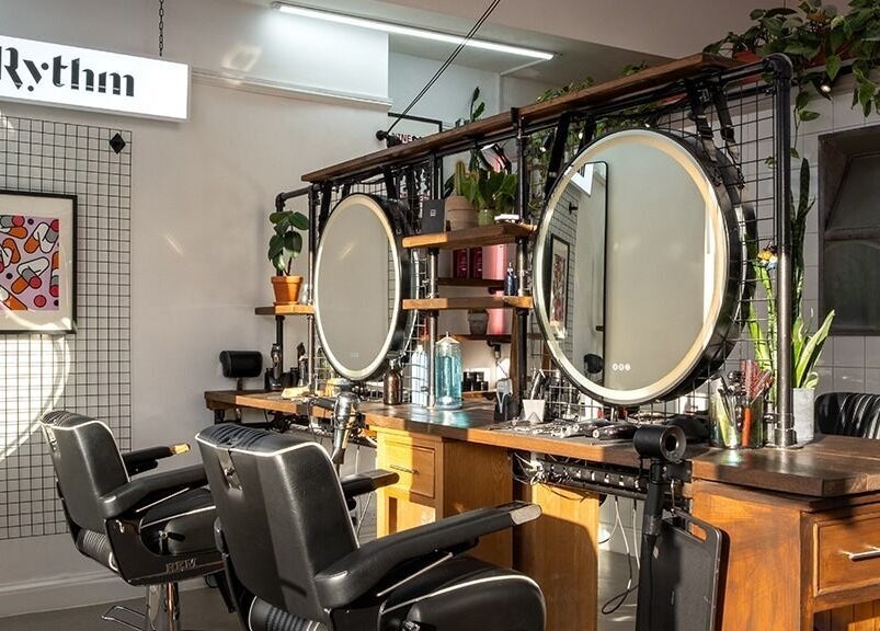 Elegant salon setup at Rythm Studio, featuring chic mirrors and plush chairs in Bristol, England, GB.