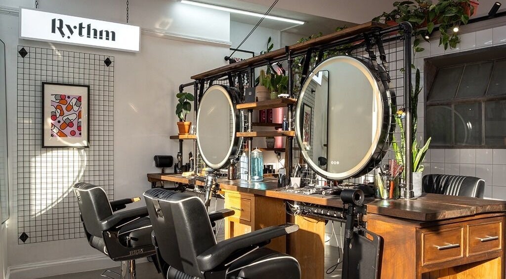 Elegant salon setup at Rythm Studio, featuring chic mirrors and plush chairs in Bristol, England, GB.