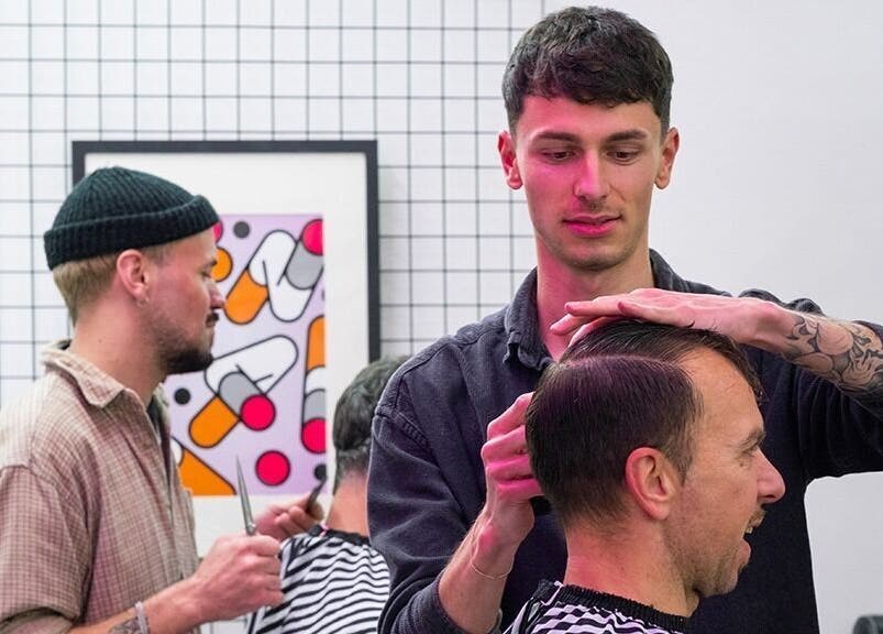 Stylists at Rythm Studio in Bristol, England, GB, crafting modern haircuts for clients in a chic salon setting.