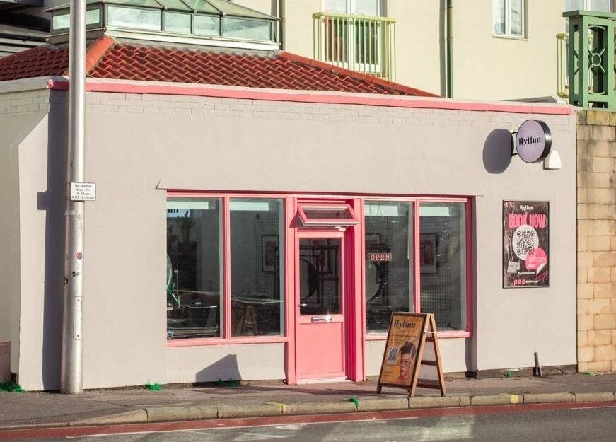 Front view of Rythm Studio in Bristol, England, GB, featuring pink accents and street signage.
