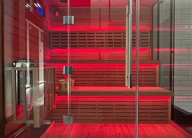 Warmly lit sauna at Recovery Space, Dubai, Dubai, AE, showcasing a serene wellness atmosphere.