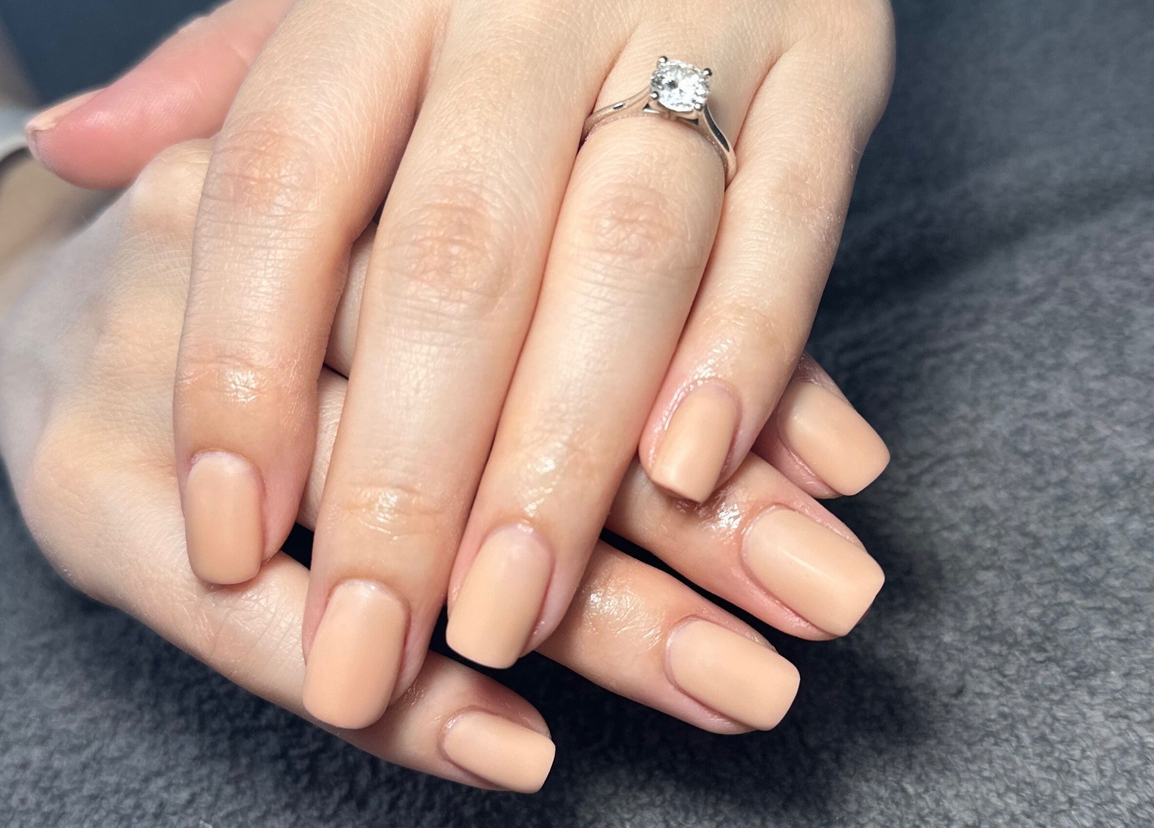 Manicured hands with nude polish at Sage beauty & aesthetics (former JJ Beauty), Wigan, England, GB.