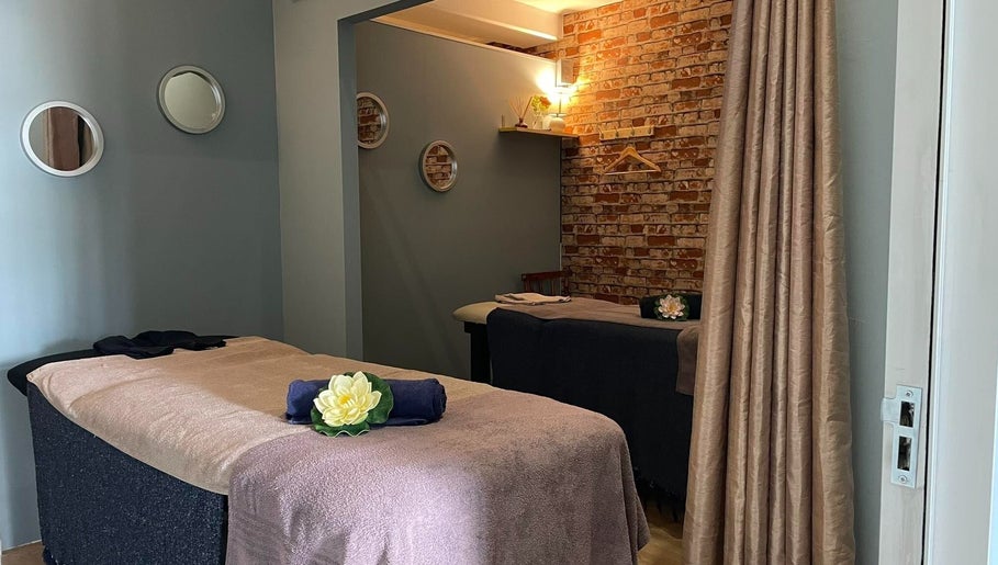 Relaxing massage room at JMS Wellness Durbanville, Cape Town, Western Cape, ZA featuring cozy beds and soft lighting.