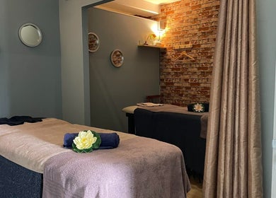 Relaxing massage room at JMS Wellness Durbanville, Cape Town, Western Cape, ZA featuring cozy beds and soft lighting.