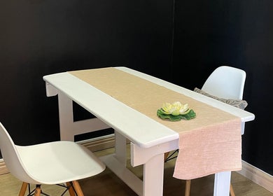 Minimalist white table setting at JMS Wellness Durbanville in Cape Town, Western Cape, ZA featuring a lotus decor.