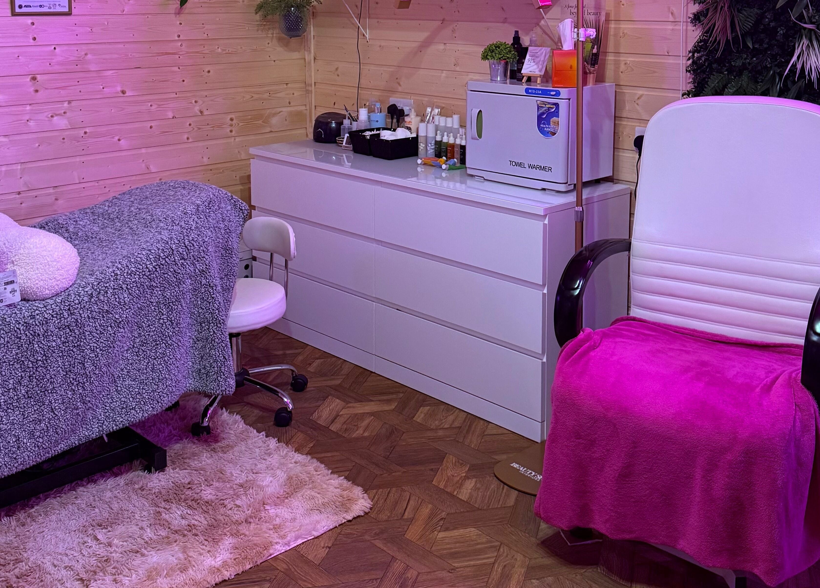 Cozy spa room at The Nest, Larne, Northern Ireland, GB with relaxing chair and treatment bed.