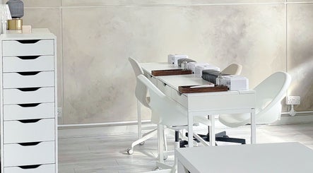 Elegant nail desk setup at Soso Beauty, Liverpool, England, GB, featuring modern white decor and storage.