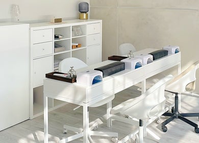 Elegant nail station at Soso Beauty, Liverpool, England, GB showcasing modern white decor.