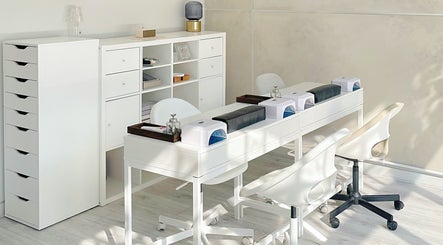 Elegant nail station at Soso Beauty, Liverpool, England, GB showcasing modern white decor.
