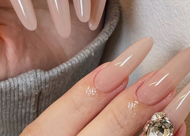 Stylish nude manicure at Soso Beauty, Liverpool, England, GB with gem accent.