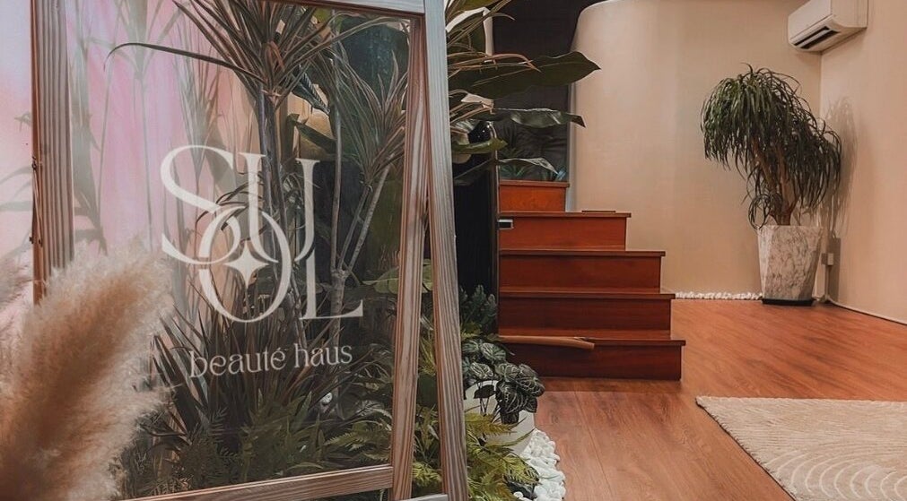 Tranquil entrance of Soul Beauté in Singapore, Singapore, SG featuring lush plants and a welcoming ambiance.