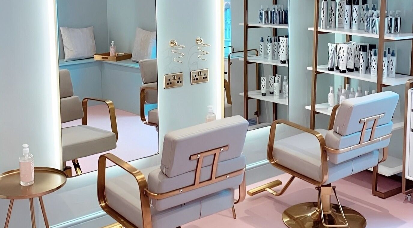 Elegant salon interior at Shelby Burton Hair, Hemel Hempstead, England, GB with stylish chairs and modern decor.