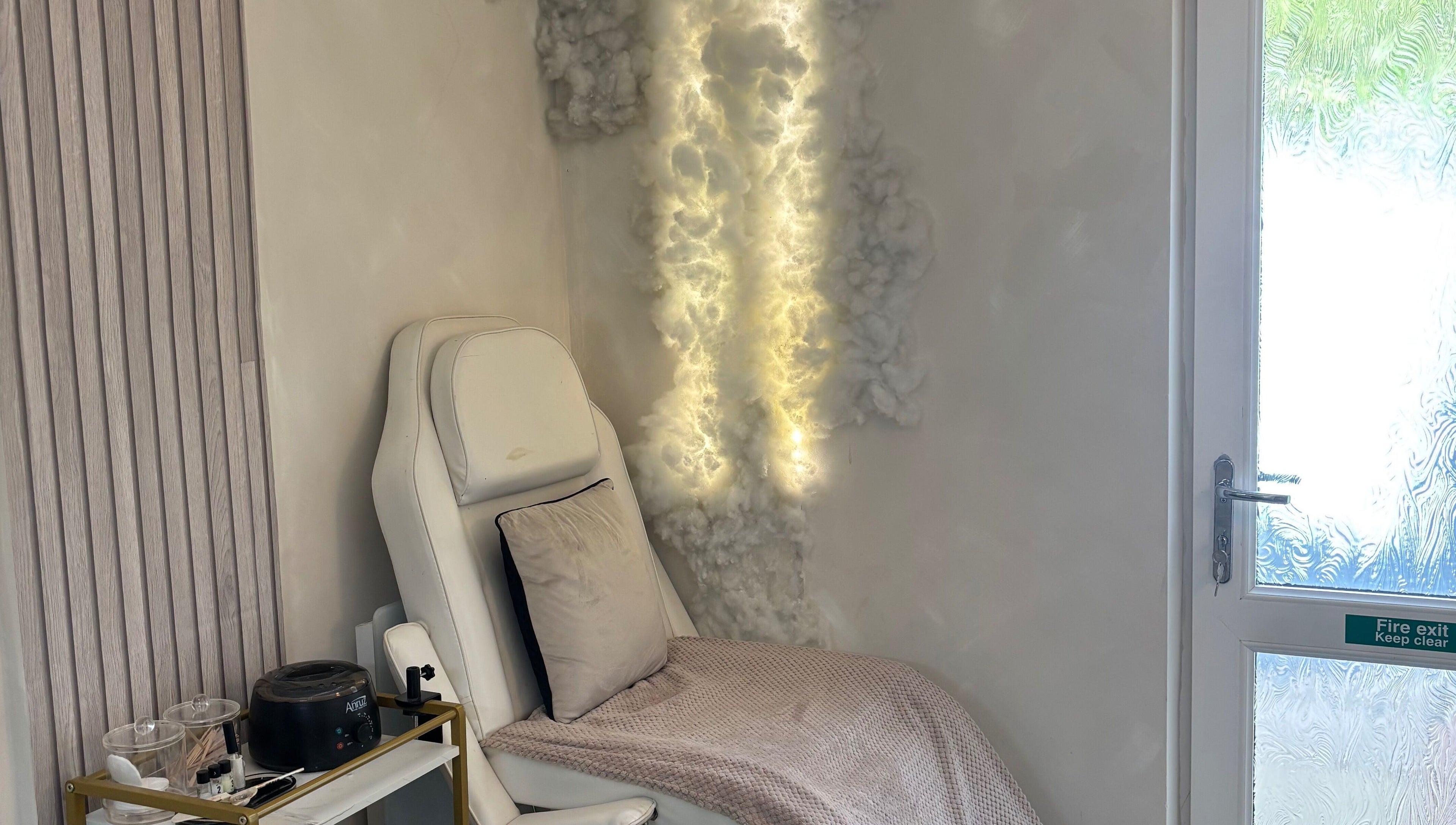 Relaxing chair with soft lighting at Normandaé Studio, Saltash, England, GB, highlighting serene ambience.