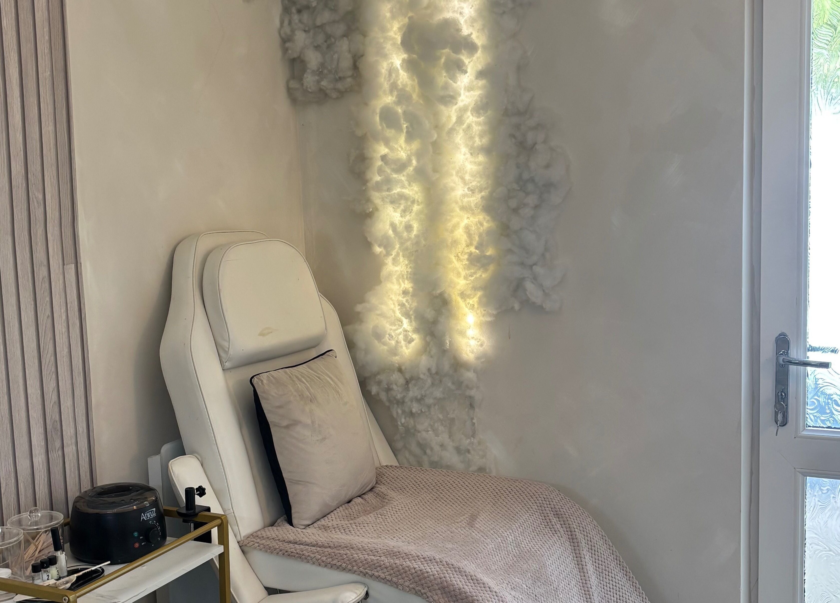 Relaxing chair with soft lighting at Normandaé Studio, Saltash, England, GB, highlighting serene ambience.