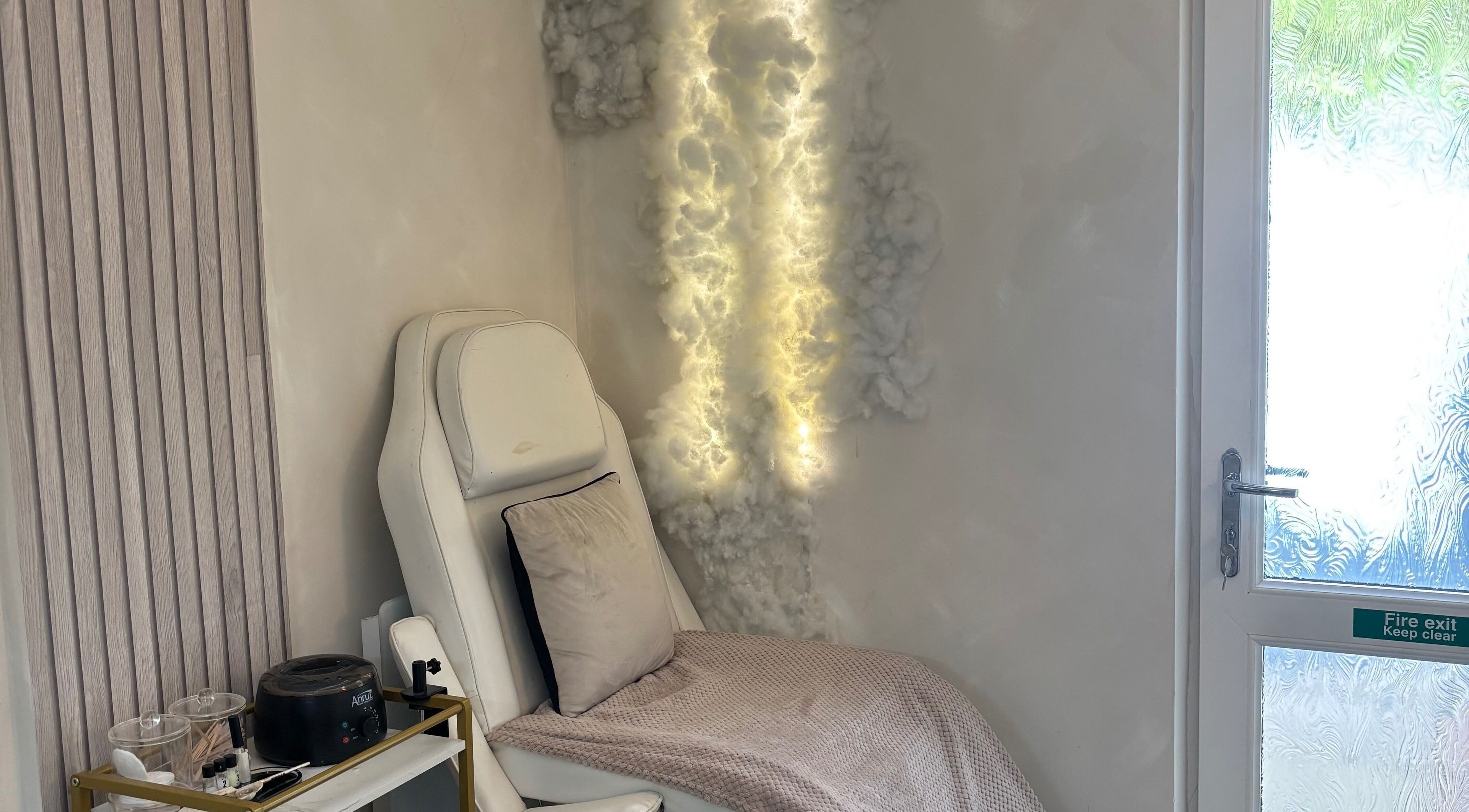 Relaxing chair with soft lighting at Normandaé Studio, Saltash, England, GB, highlighting serene ambience.