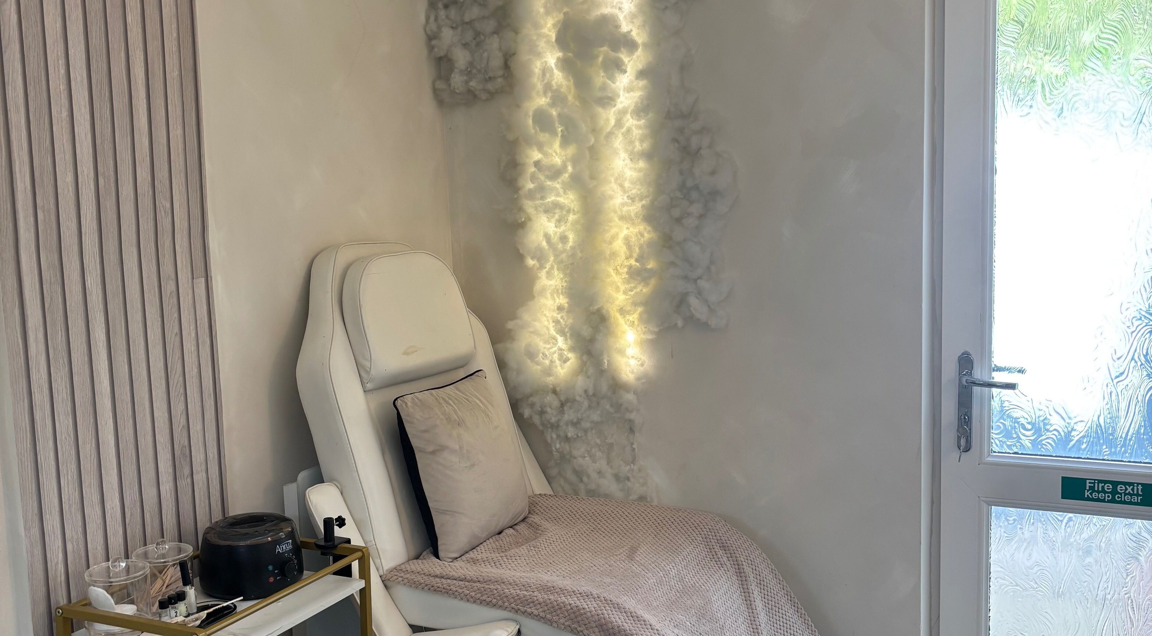 Relaxing chair with soft lighting at Normandaé Studio, Saltash, England, GB, highlighting serene ambience.