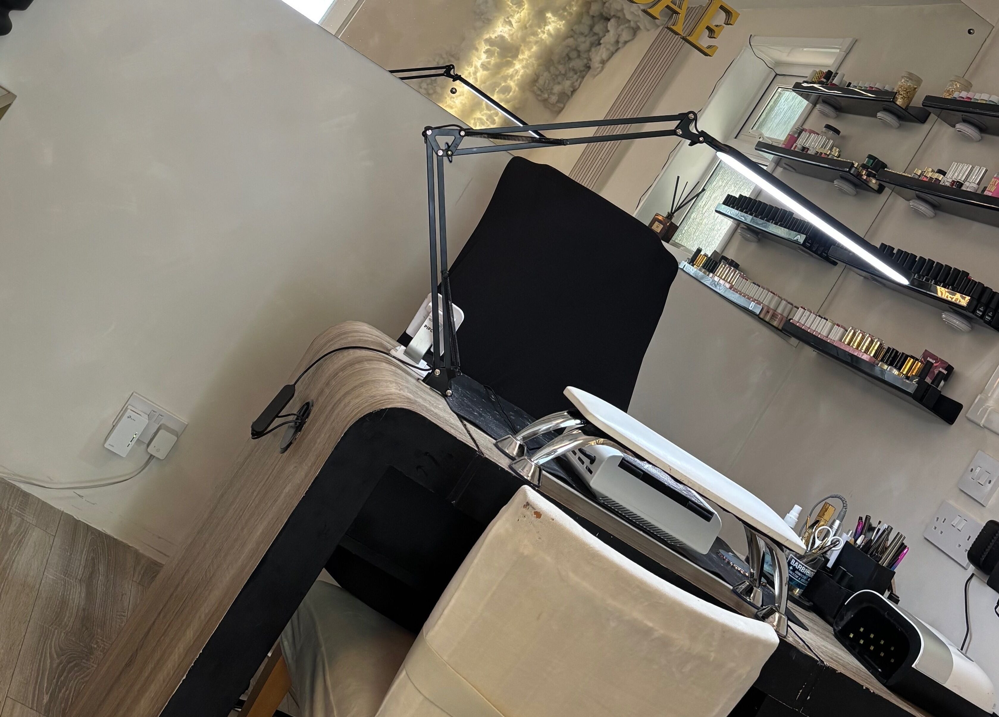 Modern nail station at Normandaé Studio, Saltash, England, GB with neatly organized shelves.