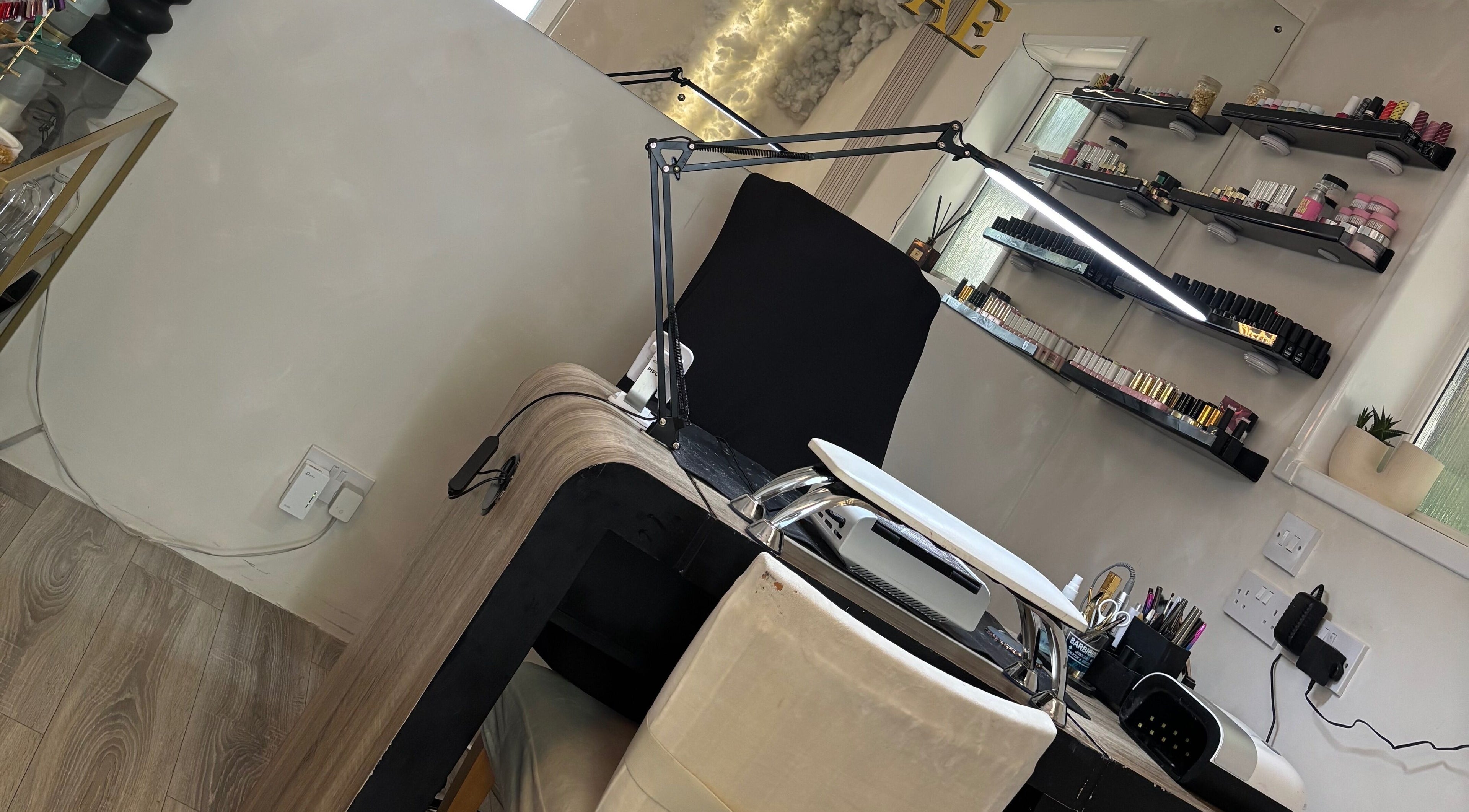 Modern nail station at Normandaé Studio, Saltash, England, GB with neatly organized shelves.