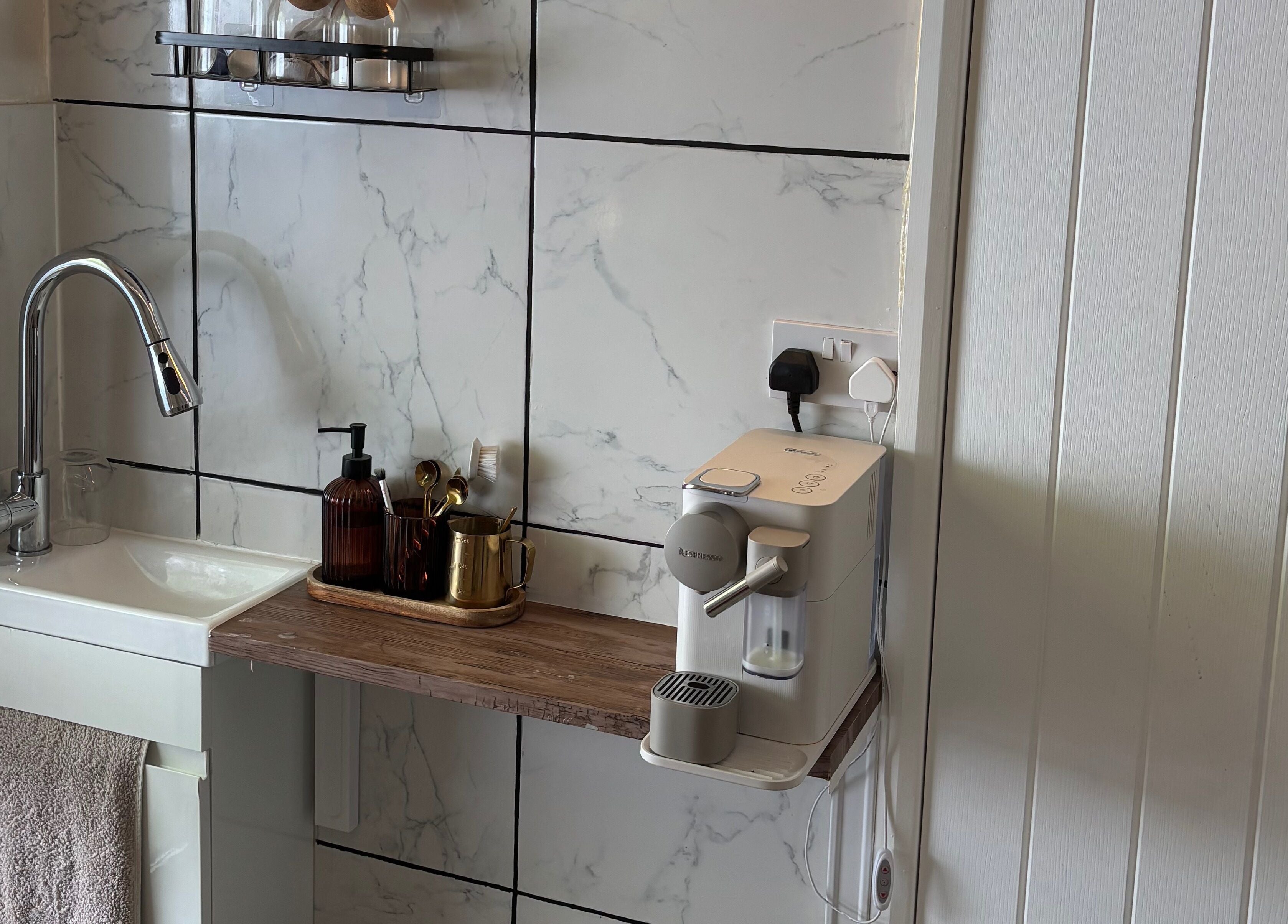 Normandaé Studio's elegant sink and coffee area with marble tiles in Saltash, England, GB.