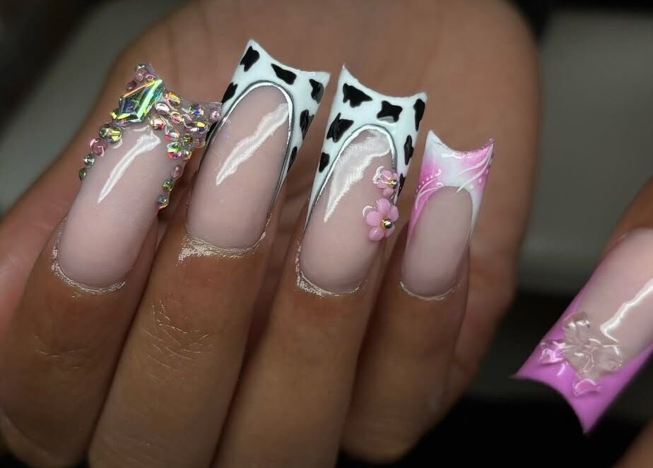 Intricate nail art at Normandaé Studio, Saltash, England, GB featuring cow patterns and gemstone accents.