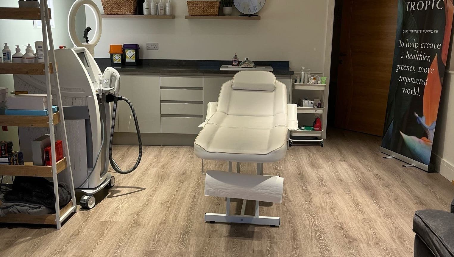 Treatment room at Glow Aesthetics in Stretcholt, England, GB with a modern spa bed and beauty equipment.