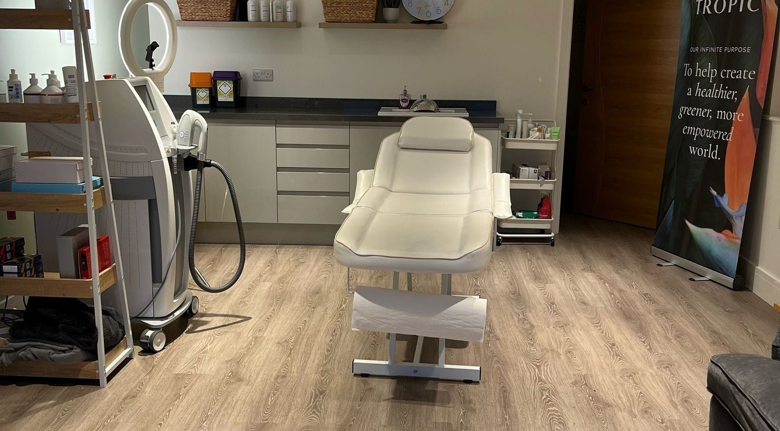 Treatment room at Glow Aesthetics in Stretcholt, England, GB with a modern spa bed and beauty equipment.