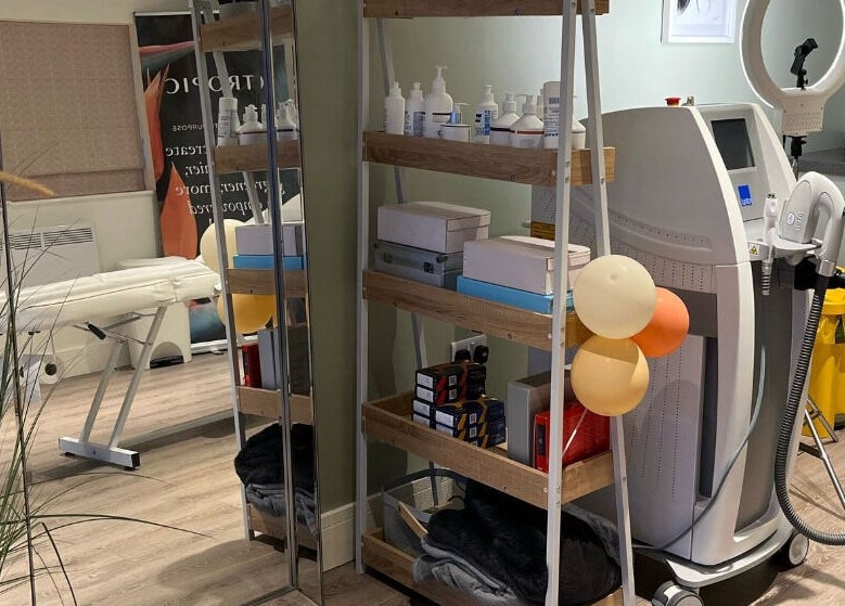 Modern treatment room at Glow Aesthetics in Stretcholt, England, GB, featuring equipment and skincare products.