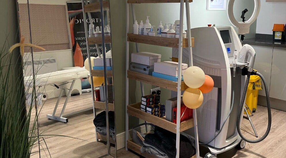 Modern treatment room at Glow Aesthetics in Stretcholt, England, GB, featuring equipment and skincare products.