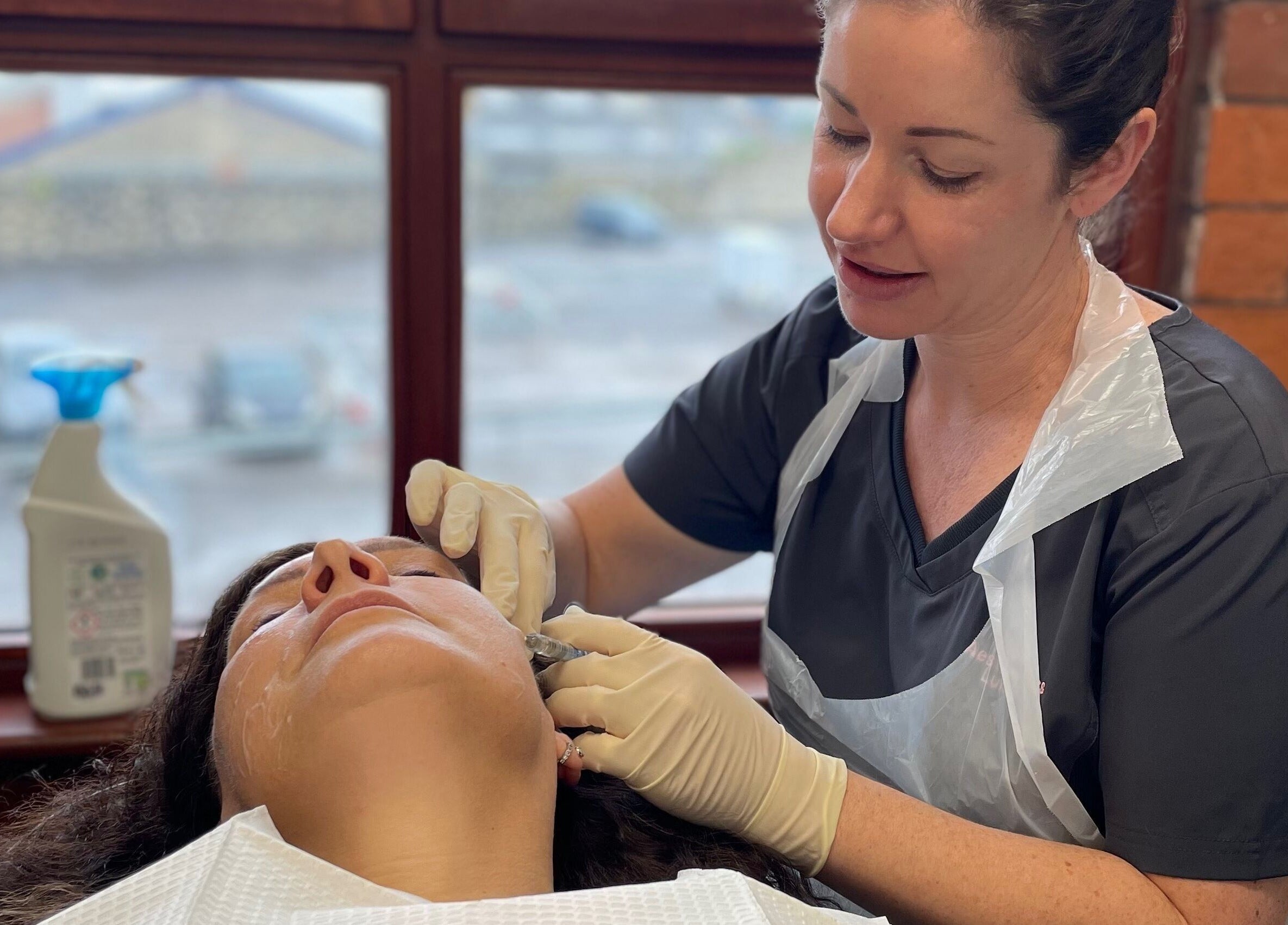 Skilled beautician at Glow Aesthetics in Stretcholt, England, GB providing micro-needling treatment.