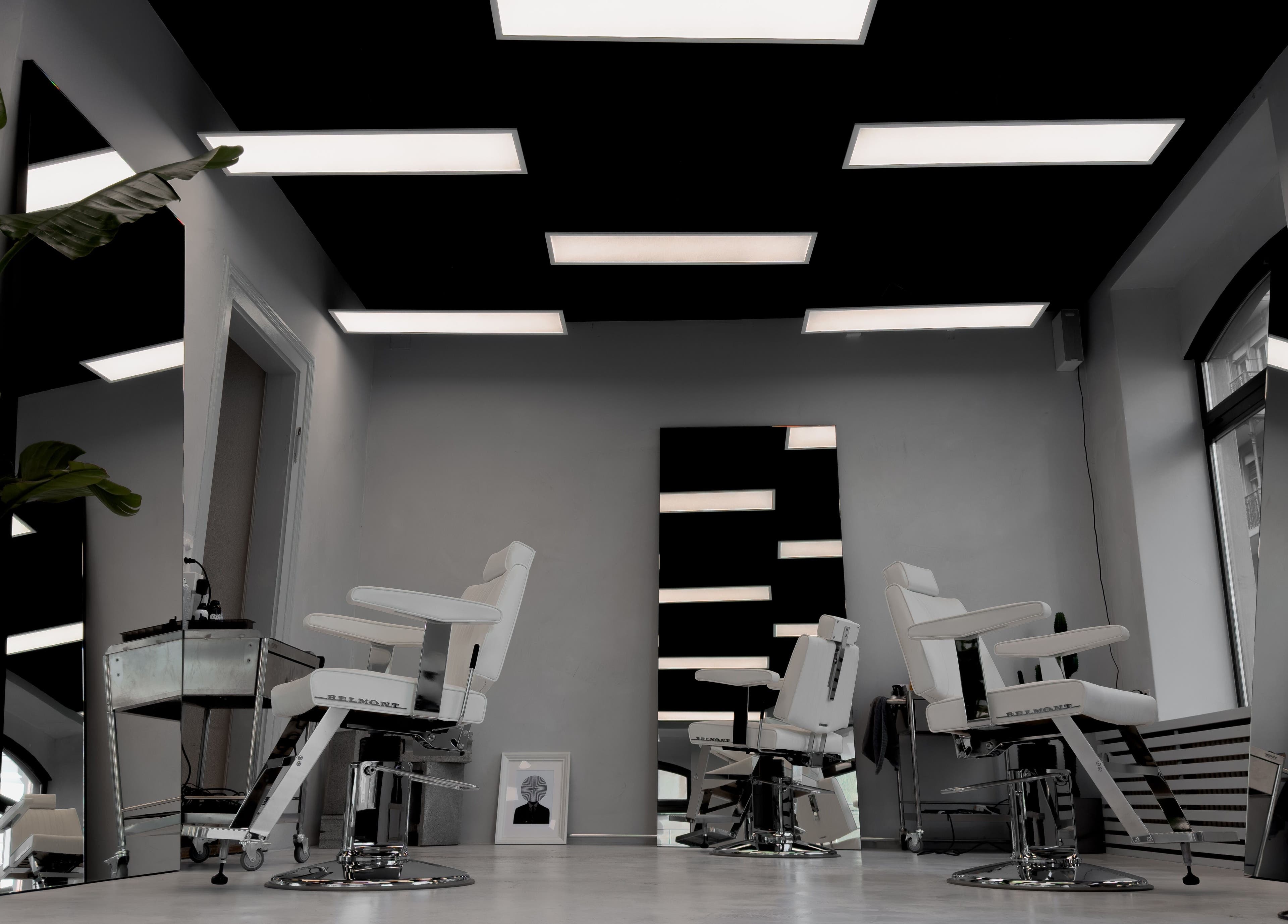 Stylish interior of Amiro Barbershop in Zürich, Zürich, CH featuring chic barber chairs and modern decor.