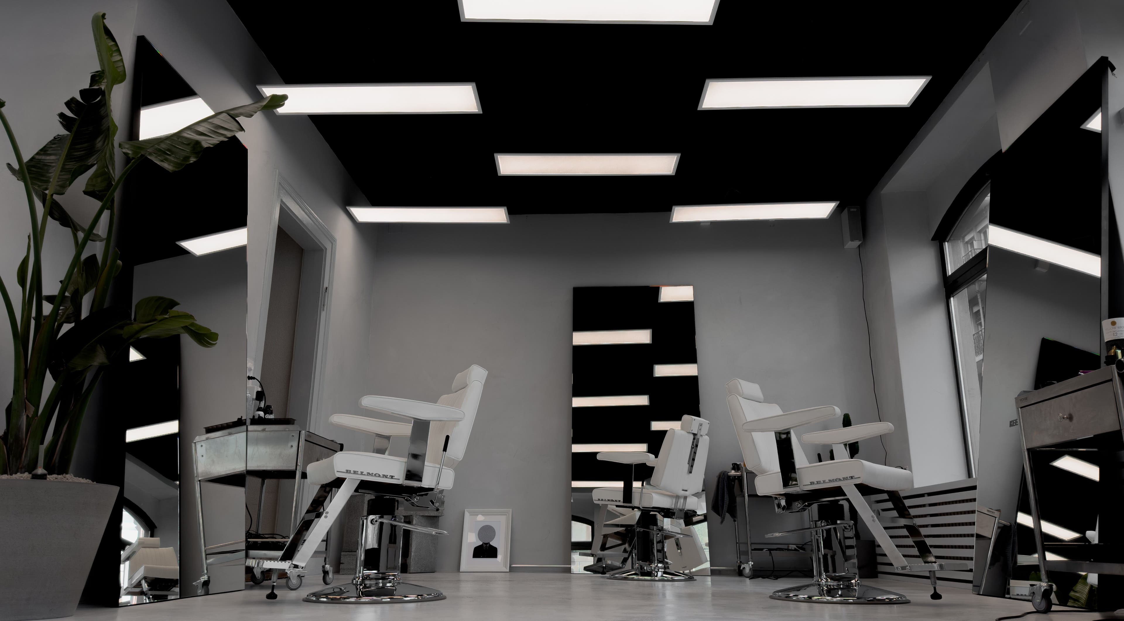 Stylish interior of Amiro Barbershop in Zürich, Zürich, CH featuring chic barber chairs and modern decor.