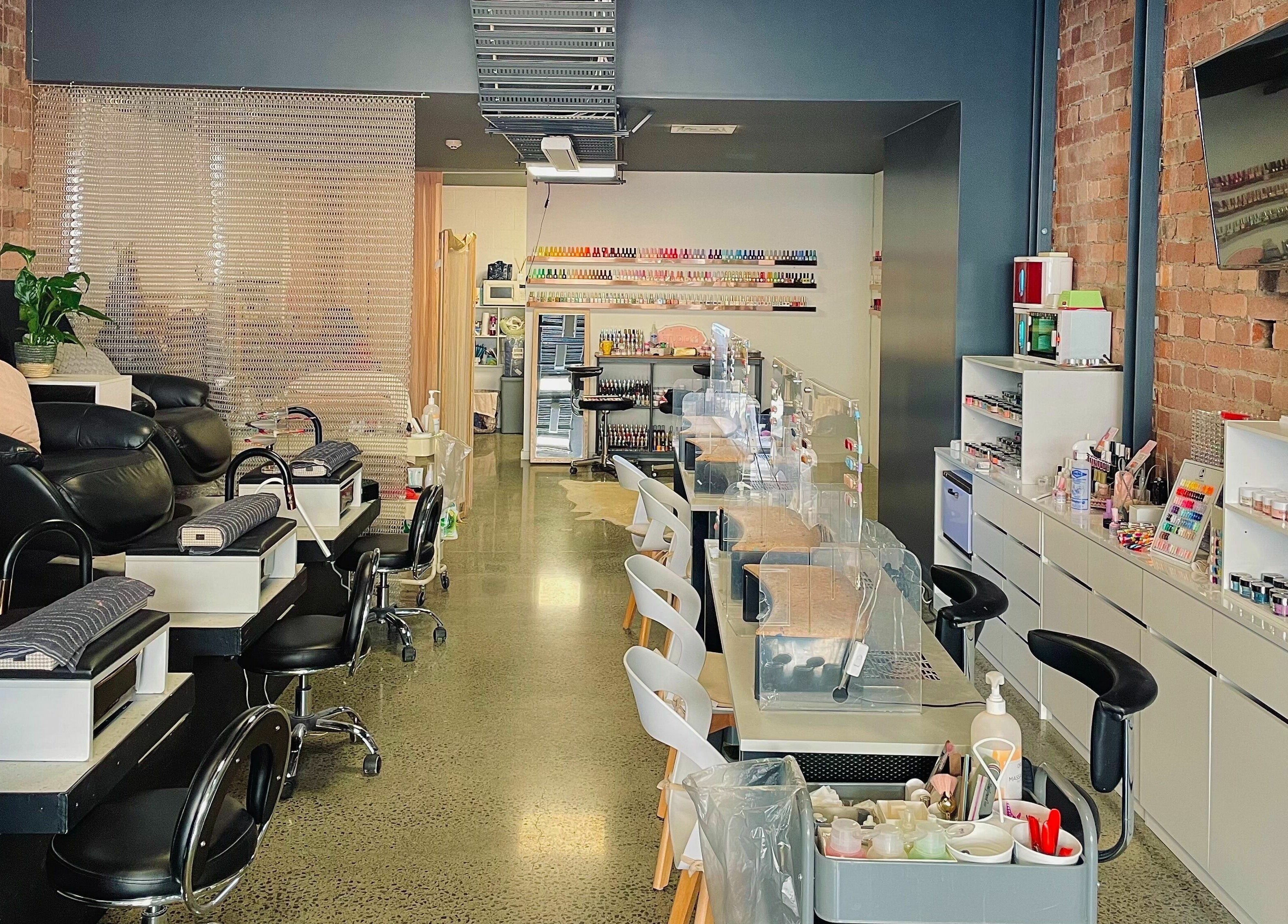 Modern nail salon interior at Studio V in Lower Hutt, Wellington, NZ, showcasing plush seating and vibrant colors.
