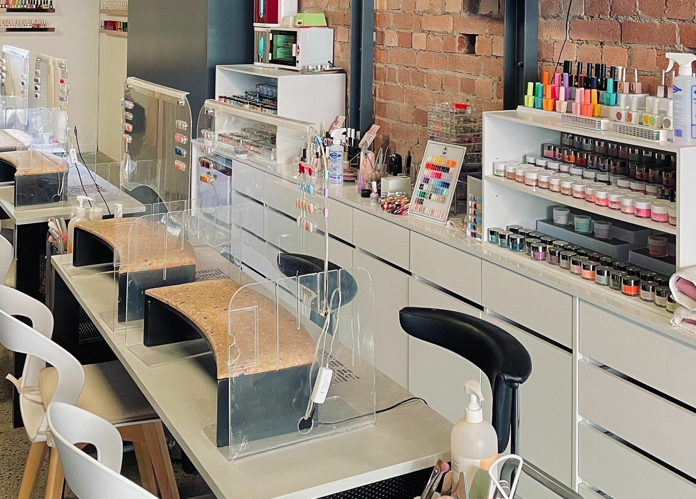 Studio V nail salon interior in Lower Hutt, Wellington, NZ showcasing modern manicure stations.