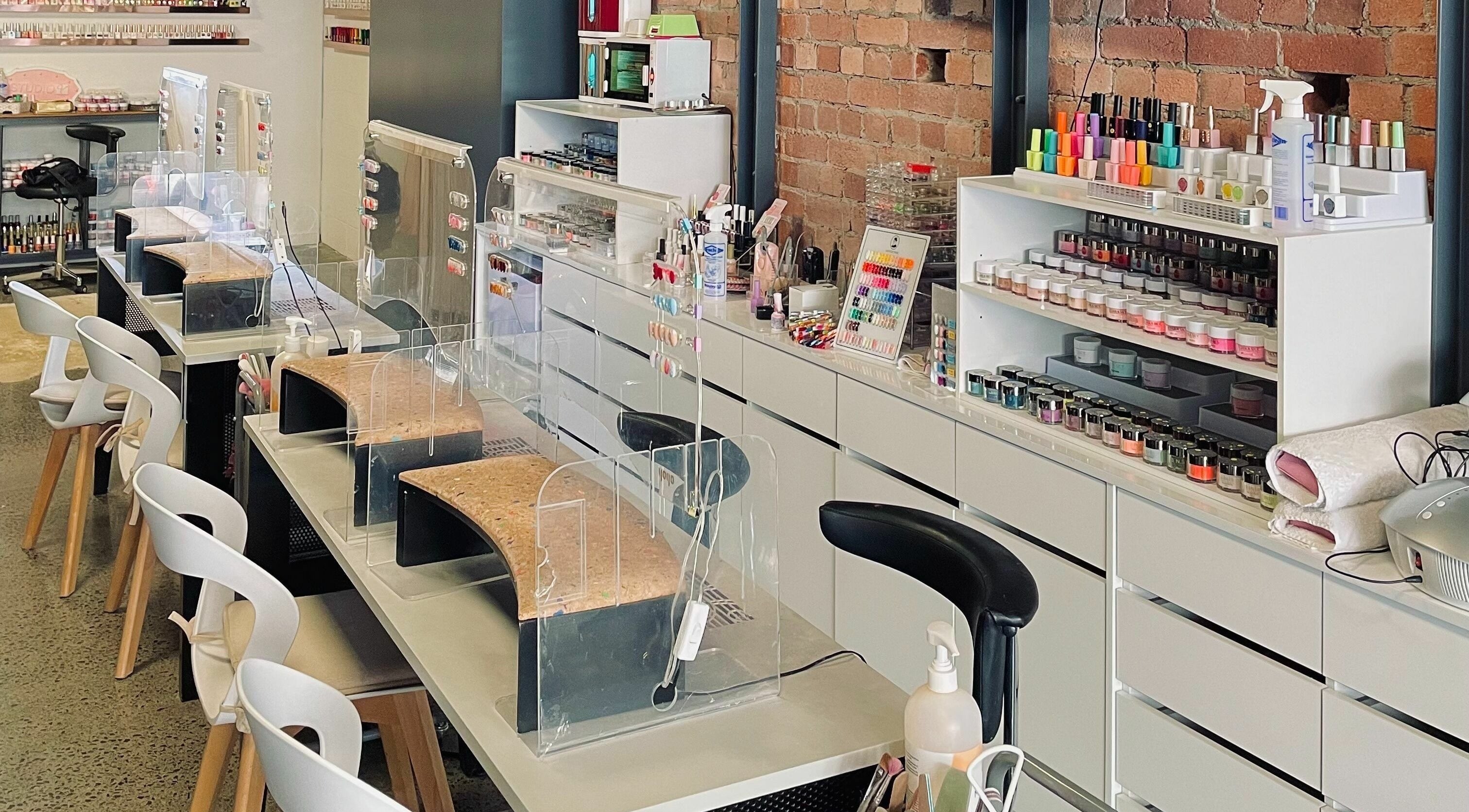 Studio V nail salon interior in Lower Hutt, Wellington, NZ showcasing modern manicure stations.