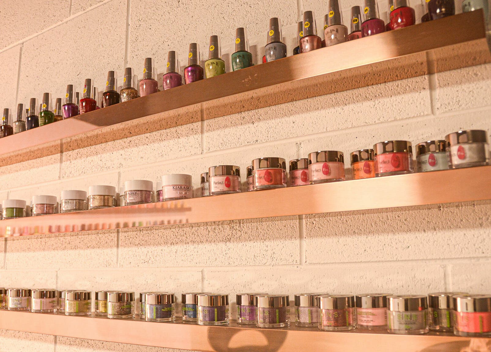Vibrant nail polish display at Studio V, Lower Hutt, Wellington, NZ, showcasing a colorful range.