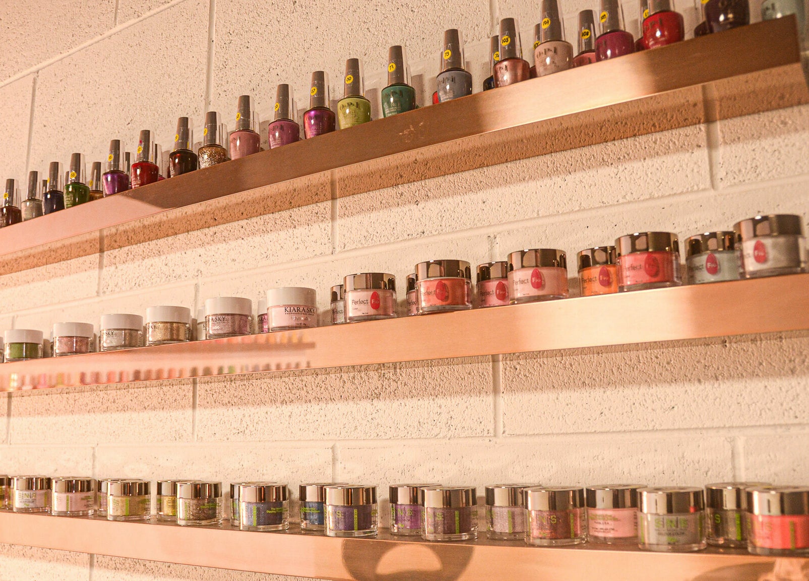Vibrant nail polish display at Studio V, Lower Hutt, Wellington, NZ, showcasing a colorful range.