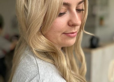 Close-up of a woman's styled blonde hair at Hair By Helena, Nantwich, England, GB.