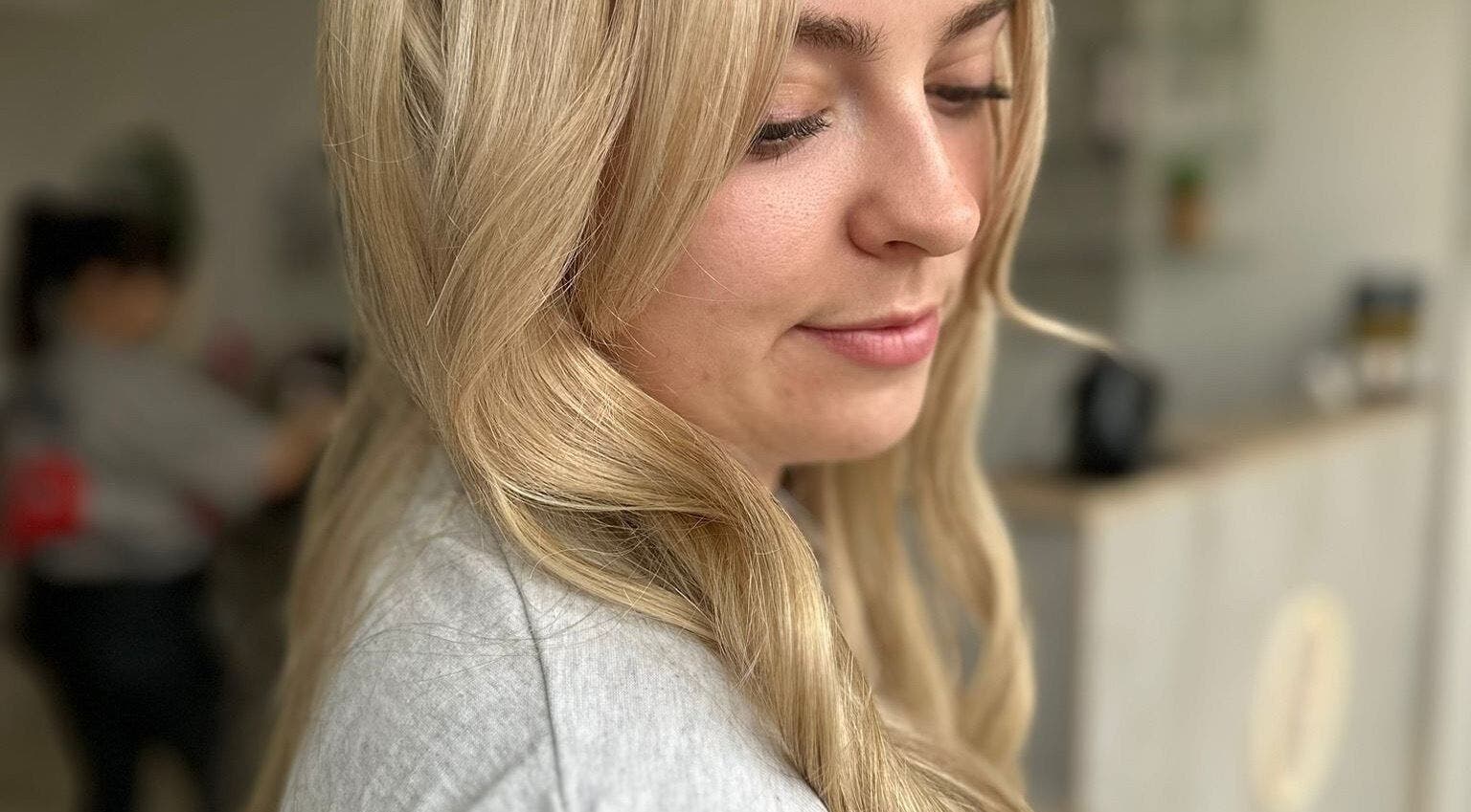 Close-up of a woman's styled blonde hair at Hair By Helena, Nantwich, England, GB.