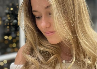 Woman with styled blonde hair at Hair By Helena, Nantwich, England, GB, showcasing expert hairdressing.
