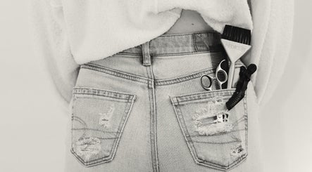 Hairdressing tools in pocket at The Beauty Loft, Marmora, Ontario, CA; showcasing chic salon style.